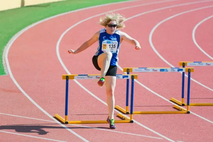 woman running on track and field