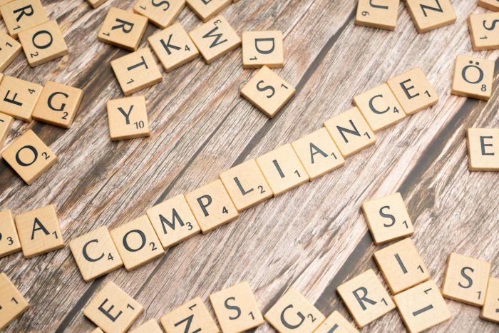 The word compliance written in scrabble letters