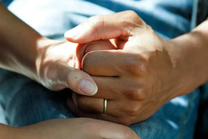 person holding patient's hand