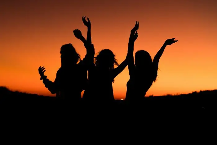 silhouette of three woman at sunset