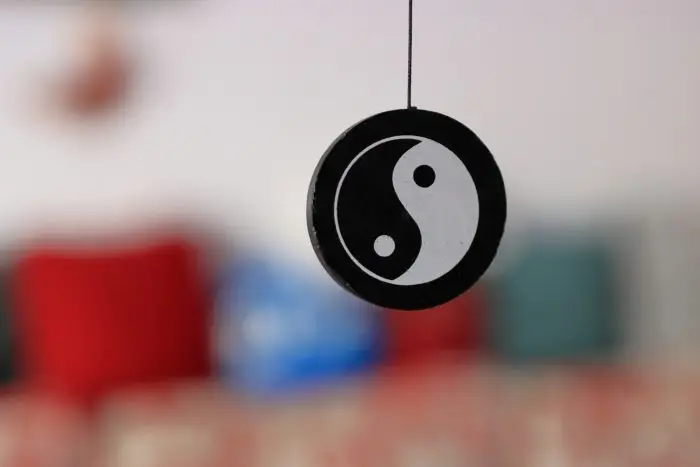 black and white yin yang sign hanging from a string