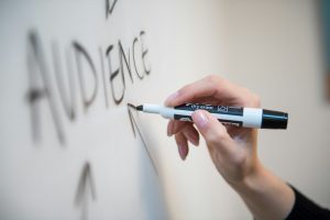 person writing on whiteboard