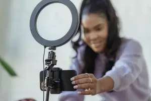 Cheerful female blogger smiling at camera