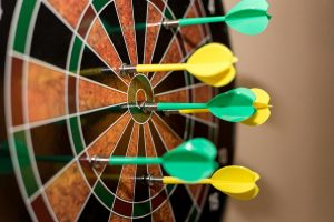 Green and Yellow Darts in Dartboard