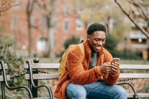 Man on smartphone in city park