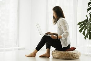 woman on chair looking at computer