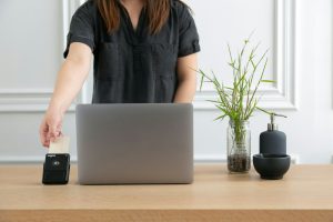 woman standing at a desk with a laptop