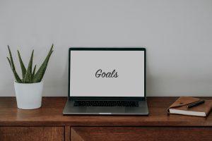 laptop sitting on top of wooden desk