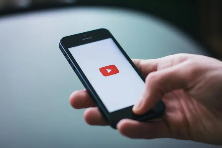 Close-up of a hand holding smartphone watching video