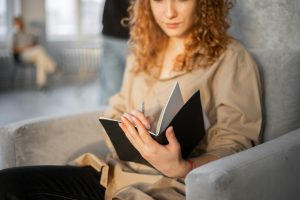 Young female with pen taking notes