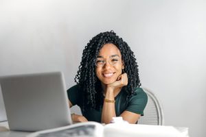 Joyful businesswoman with curly hair smiling