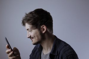 man looking at smartphone