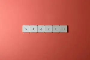 white tiles spelling 'search' on a bold red surface