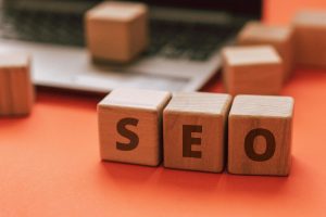 Wooden blocks spelling SEO on a laptop keyboard