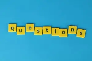 Yellow letter tiles spell 'questions'