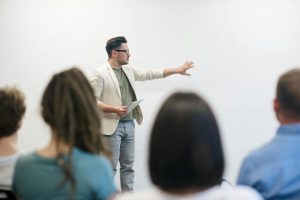 man in a blazer gives a presentation