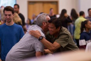 two men hugging at health fare