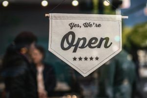 Welcoming open sign displayed in shop window