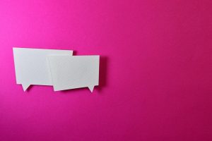 White speech bubbles on pink background