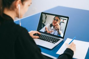 Woman participating in a virtual meeting on laptop