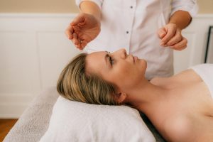 Woman receiving acupuncture forehead