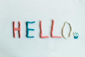 hello greeting spelled out with colorful clay on a white background