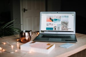 laptop on table near cup