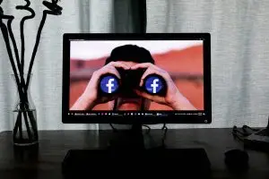 television showing man using binoculars social media icon