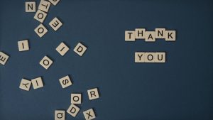 Top view of scattered letter tiles with word Thank You