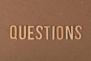 Wooden letters spell "QUESTIONS"