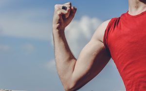 Close-up of a flexed arm in a red shirt