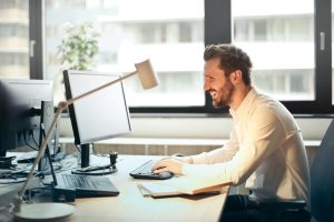 Man smiling while working at an office desk