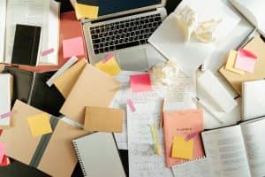 Messy study desk with laptop