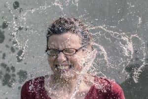 woman splashes water in her face