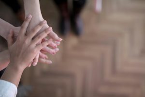 Hands stacked showing teamwork and unity