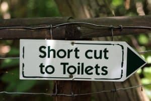 shortcut to toilets sign