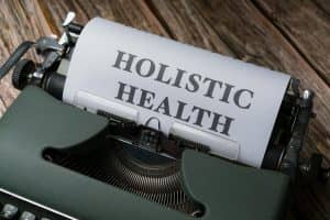 Vintage typewriter with 'Holistic Health' on paper