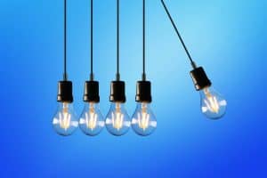 Hanging Edison-style light bulbs against a vibrant blue