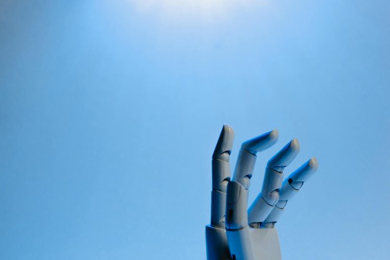 Robotic hand with articulated fingers reaching towards the sky