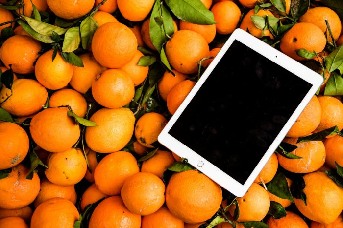 Fresh oranges with a tablet