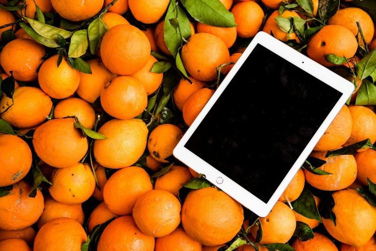 Fresh oranges with a tablet
