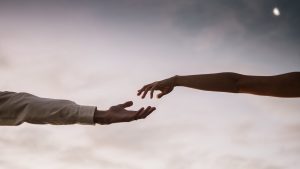 Two hands reaching towards each other