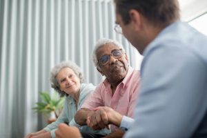 Elderly couple discussing with a consultant