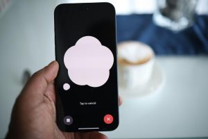 Close-up of a smartphone in hand with AI voice chat bubble