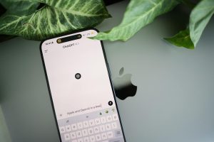 Smartphone shows a AI interface placed next to plant