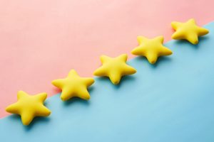 Yellow stars on pink and blue pastel background