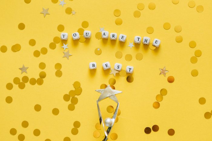 'You Are the Best' message and star confetti on a golden background.