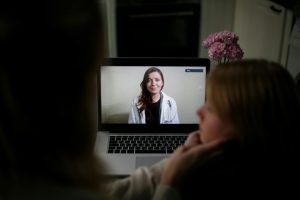 Doctor appears on a laptop screen online consult