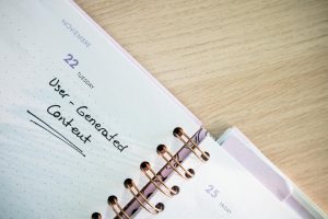 Open planner showing a date with handwritten notes on a wooden desk.