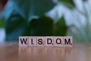 Wooden tiles spelling wisdom